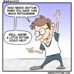 A colorful cartoon by Madscott shows a smiling, bespectacled man with short brown hair, pointing with one hand and raising the other in a “rock on” gesture. He wears a white T-shirt with blue sleeves and blue pants, standing in a confident, exaggerated pose. The speech bubble above him reads, “Who needs rhythm when you have this much enthusiasm.” Another speech bubble responds, “Well, maybe a little rhythm could help.” The website madscottcomic.com appears at the bottom.